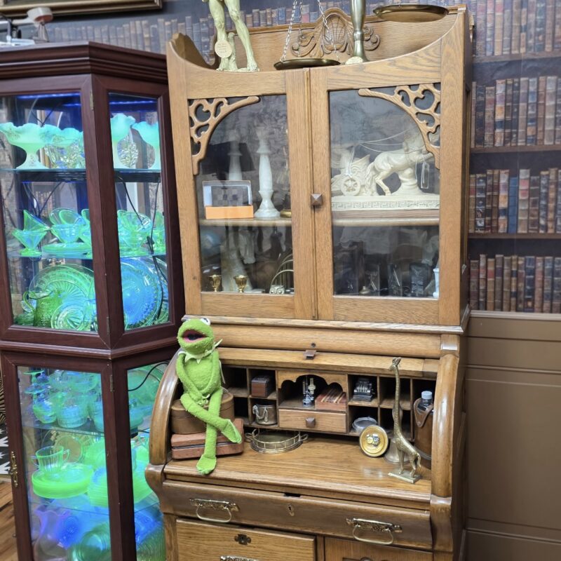 Victorian oak roll-top secretary desk with glass hutch, carved details, and brass hardware — antique writing and display furniture.