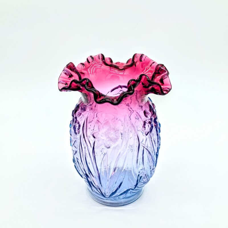 Fenton blue to pink ombré ruffled art glass vase with floral embossed pattern and fluted rim.