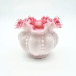 Short rounded Fenton pink and white satin glass vase with ruffled edge and beaded design.