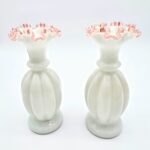 Pair of tall Fenton pink and white opalescent glass vases with ruffled edges and ribbed design.
