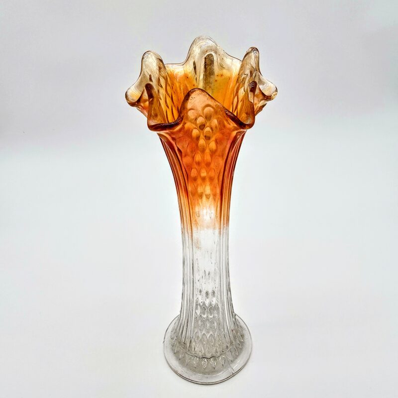 Orange fluted glass vase with hobnail texture and ruffled rim transitioning from clear to amber.
