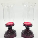 Pair of red Waterford glass candle holders with clear fluted hurricane tops, vintage crystal lighting décor.