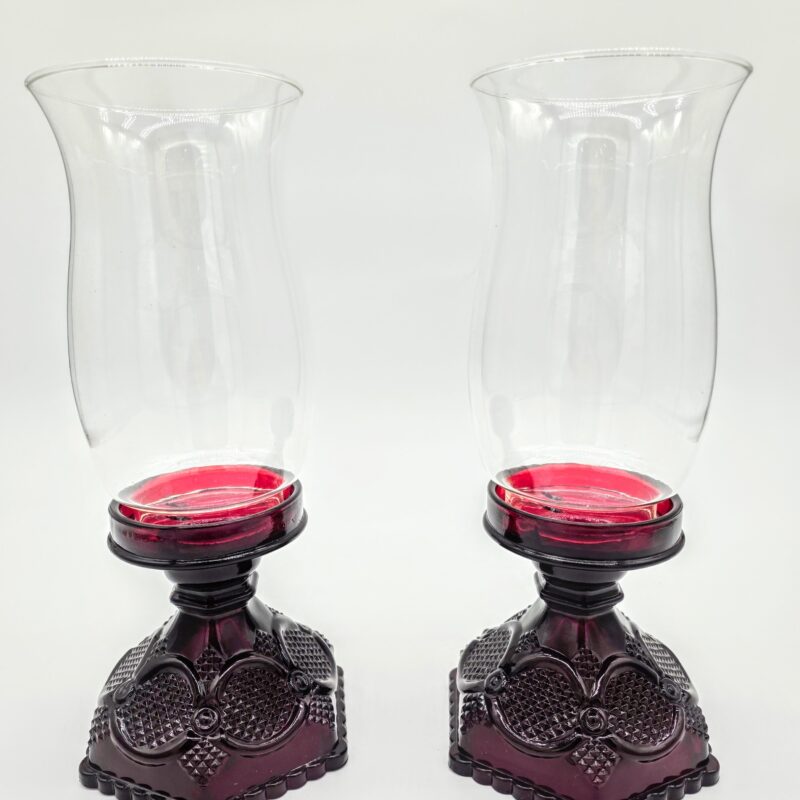 Pair of red Waterford glass candle holders with clear fluted hurricane tops, vintage crystal lighting décor.